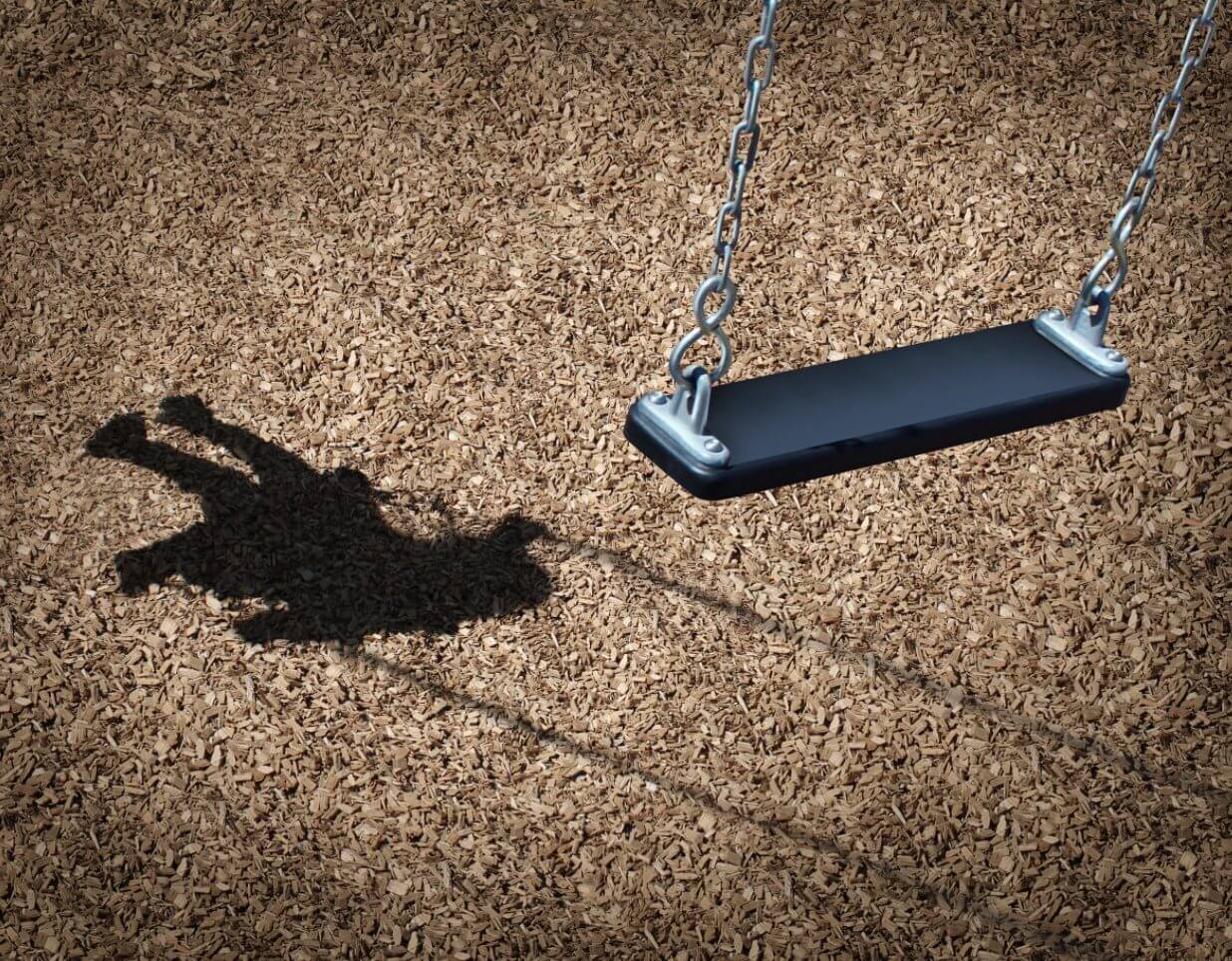 Child's shadow on a park swing