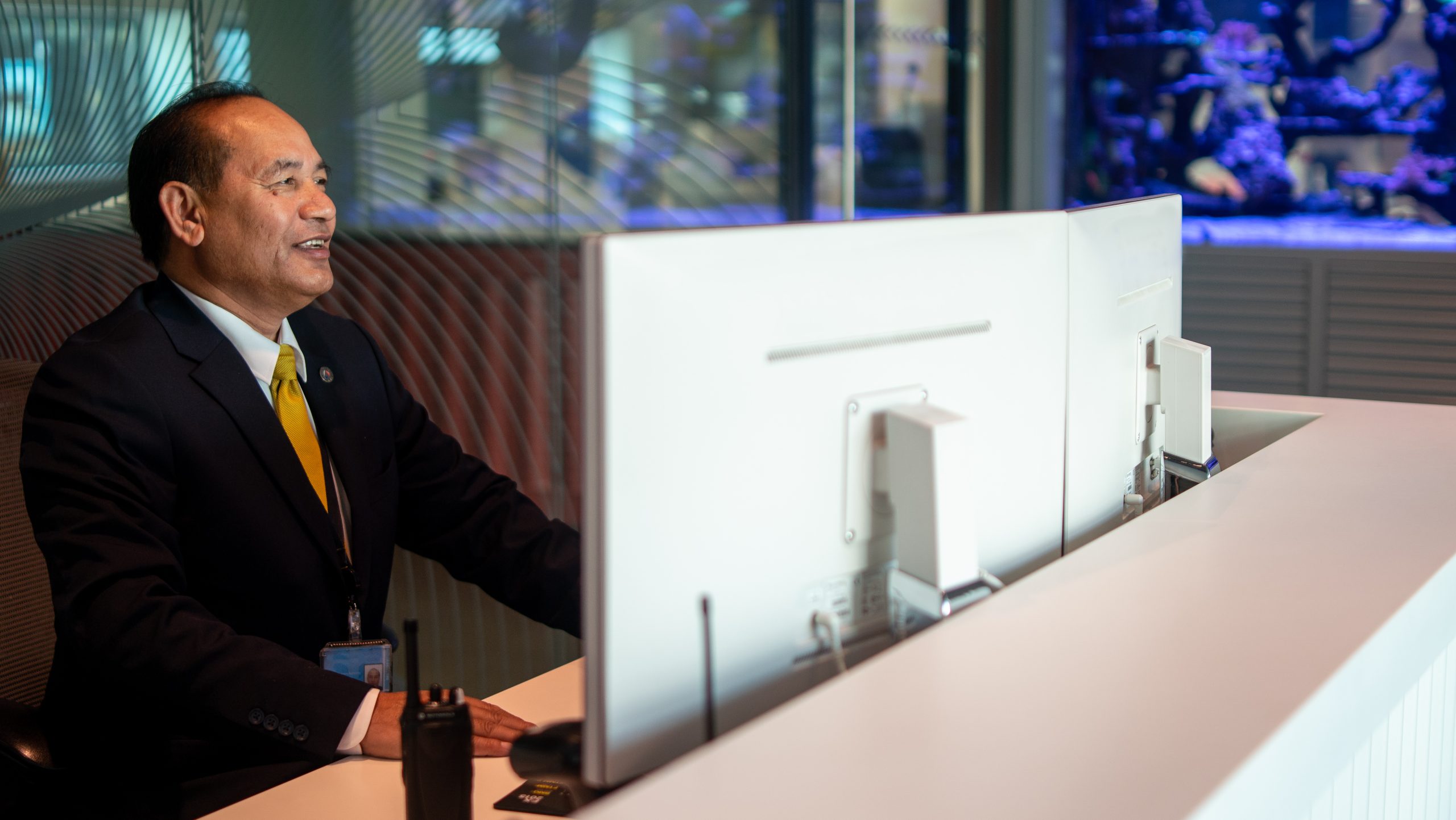 Security Guard stands at the front desk of a building