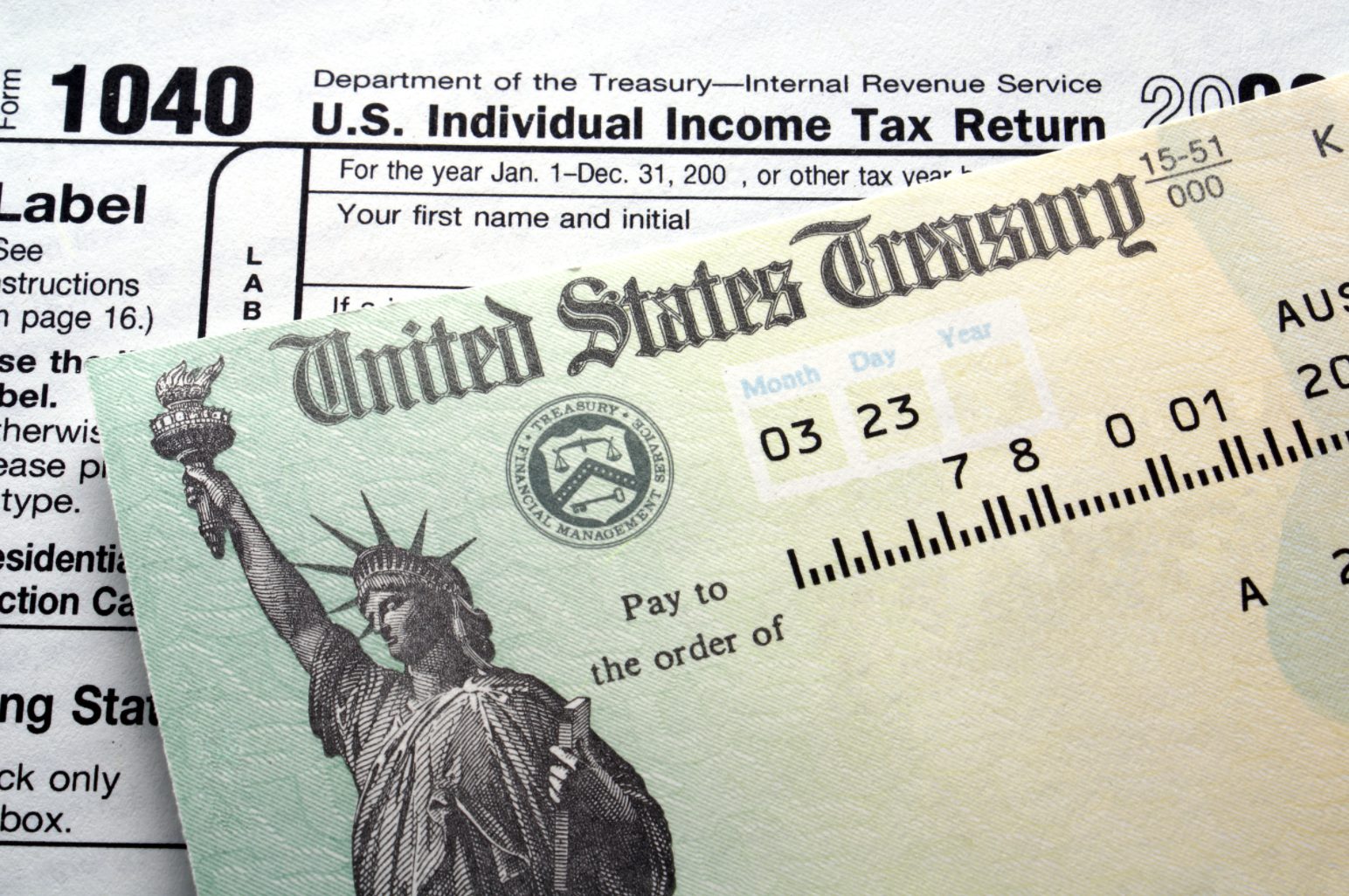 1040 tax return form with a treasury bond on top