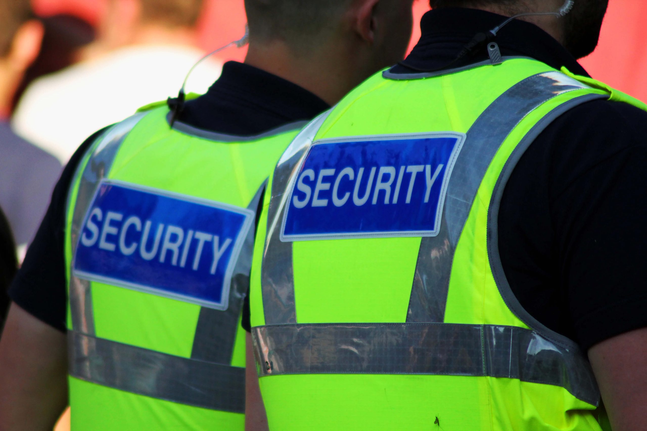 Two security guards in bright vests