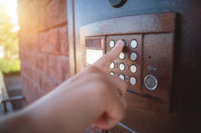 Person pressing an intercom button