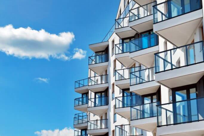 Apartment balconies pictured during a sunny day