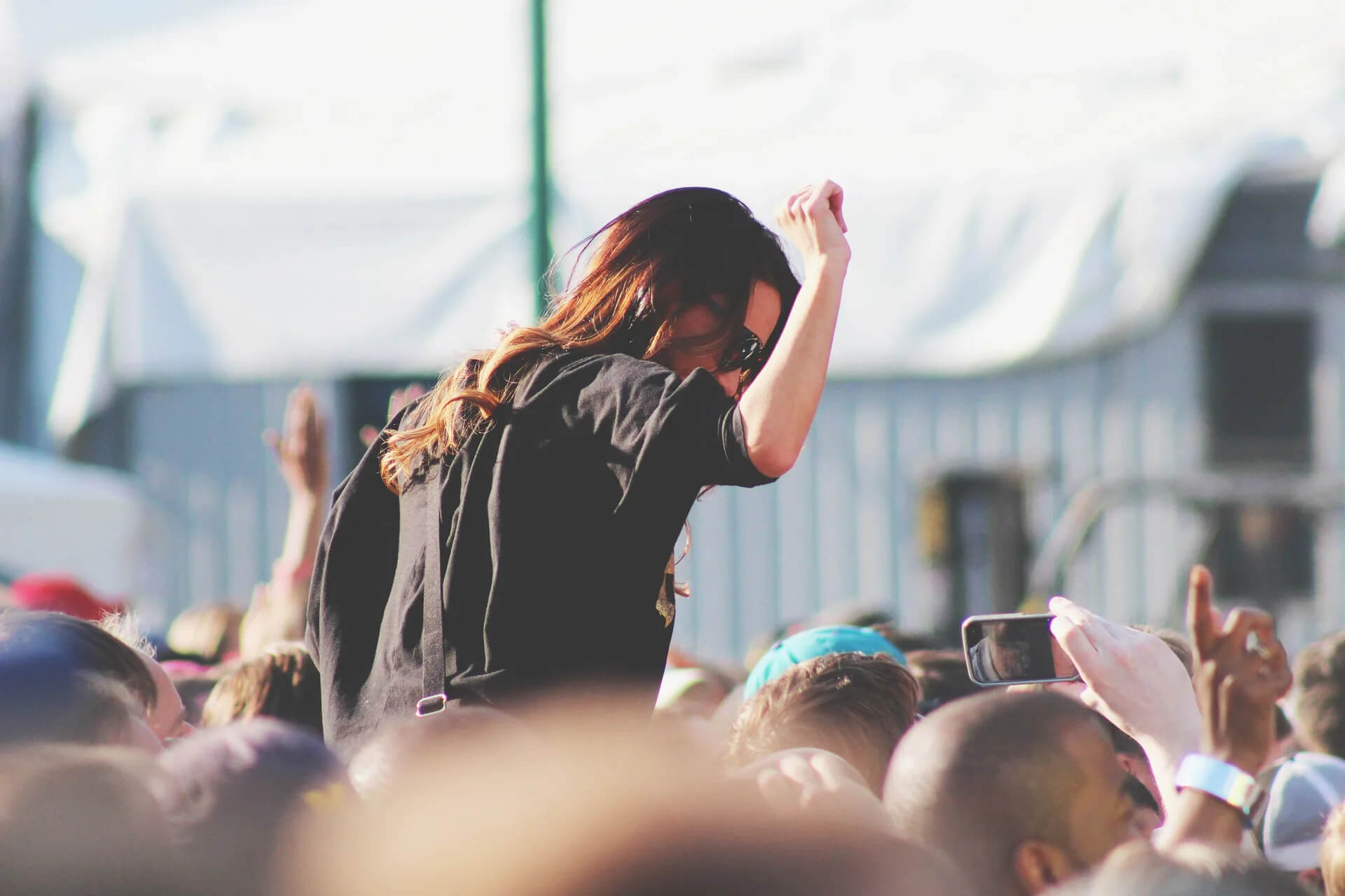 Woman dancing while on someone's shoulders