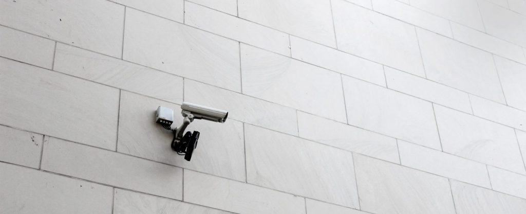 A security camera is mounted on an outdoor wall